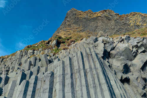 Wallpaper Mural Iceland cliff and rock formation on black beach with blue sky Torontodigital.ca