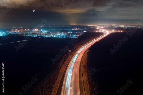 Highway road and illuminated city at night