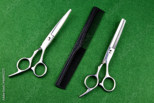 Hairdressing Scissors with Shears and Comb on a Green Felt Table