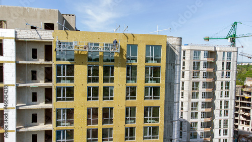Building external wall thermal insulation with mineral wool. Exterior passive house wall heat insulation with mineral wool. Insulation the facade of commercial building. Energy efficiency