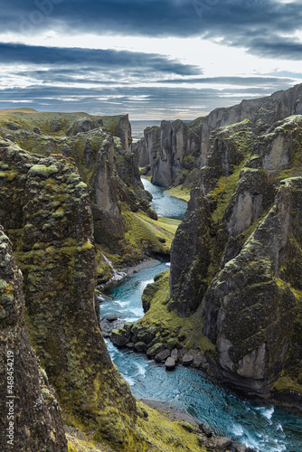 Iceland Fjaðrárgljúfur canyon with river and green rock formations