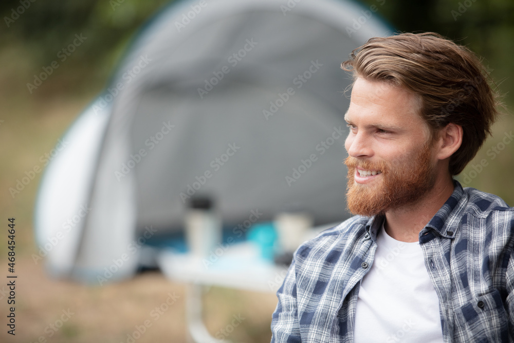 Fototapeta premium handsome cheerful man camping outdoors