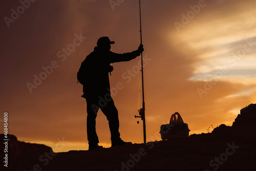 Silhouette of Fisherman at Sunset