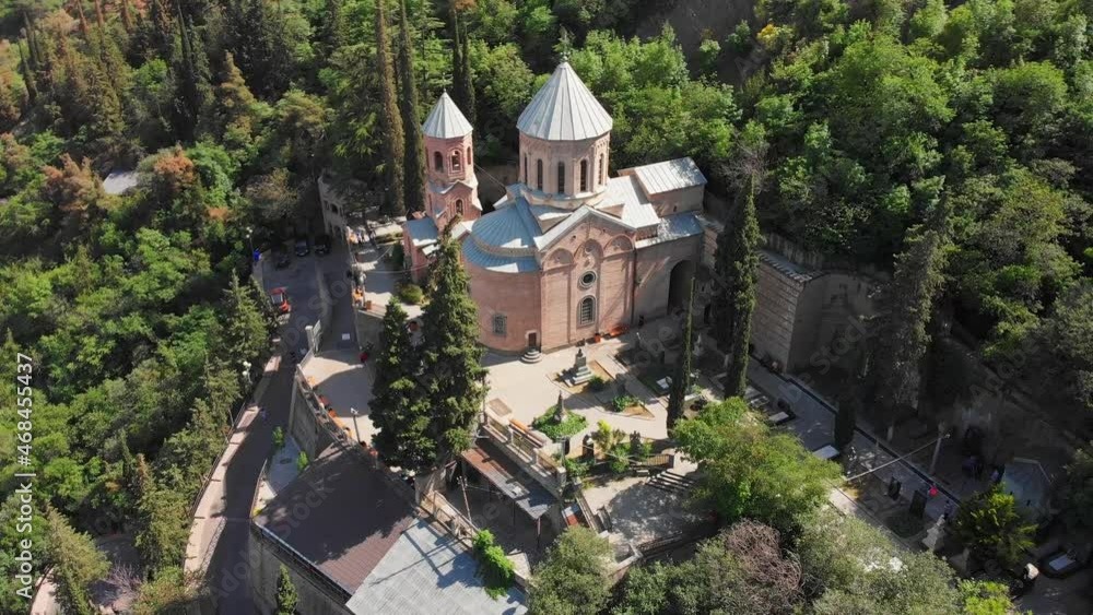 Aerial tilt down view St. David's Church called Mamadaviti on the slope of Mount Mtatsminda. Mtatsminda Pantheon of Writers and Public Figures is located around St. David's church Aerial tilt down view St. David's Church called Mamadaviti on the slope of Mount Mtatsminda. Mtatsminda Pantheon of Writers and Public Figures is located around St. David's church
