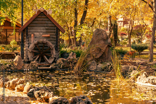 Autumn in the park. Decorative mill and pond. Loga Park. Kamensk-Shakhtinsky. Rostov region. Russia