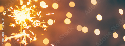 sparkler in the hands of a woman, christmas background, vintage colors