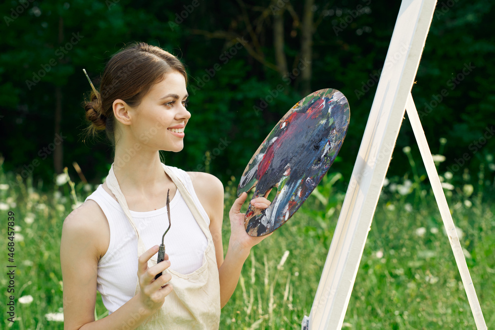 cheerful woman paints a picture palette nature landscape cheerful woman paints a picture palette nature landscape