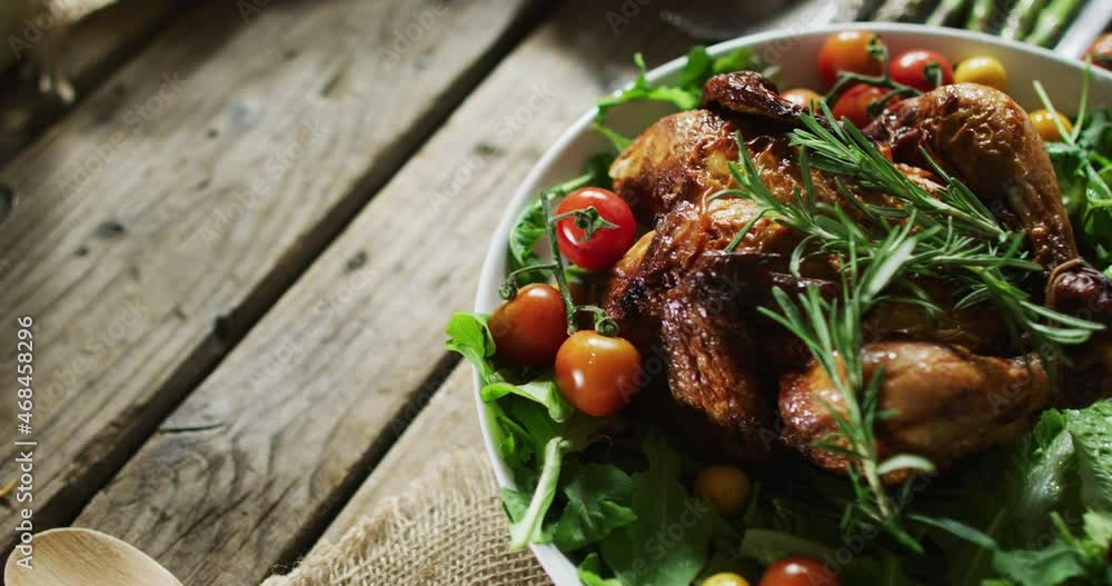 Close up view of cooked chicken and multiple food ingredients on wooden surface Close up view of cooked chicken and multiple food ingredients on wooden surface
