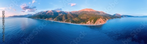 Aerial, panoramic view of a wild Mediterranean coast. Seascape, mountains and sea. Albania coast Deep azure sea, warm colored rocks and mountains, blue sky. Saranda, Albania travel concept.