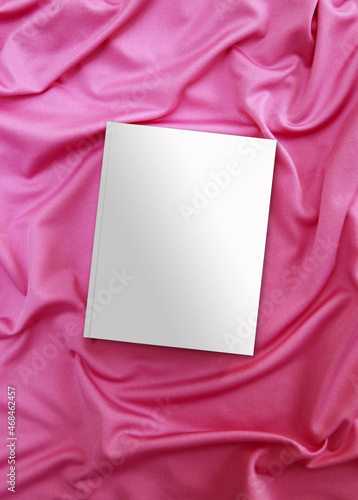 An empty catalog, magazines, a book layout on a pink background. Fabric background. top view, mock-up