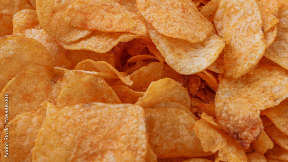 Fototapeta premium Potato chips or crisps . Close-up of potato chips or crisps. Food background.