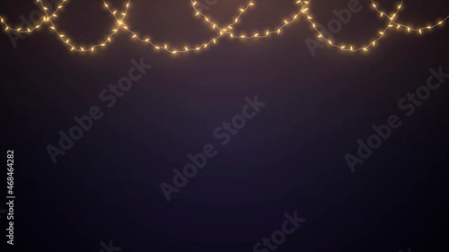 Hanging glowing garlands with golden light bulbs on dark background