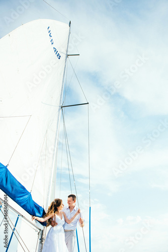 young couple guy and girl on a sailing yacht