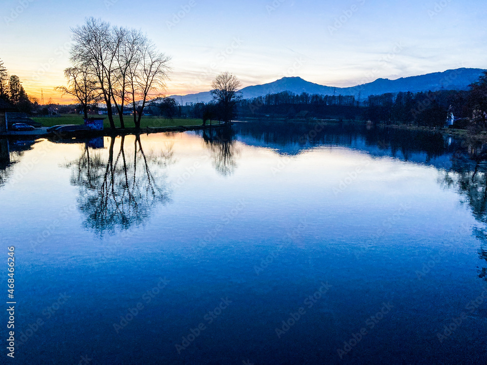 sunset with reflection in the river in wangen an der aare, switzerland