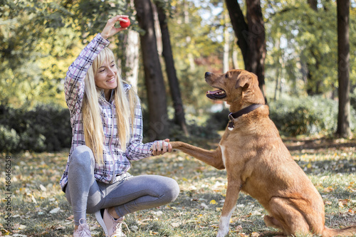 Positive young woman enjoying happy moments with her dog