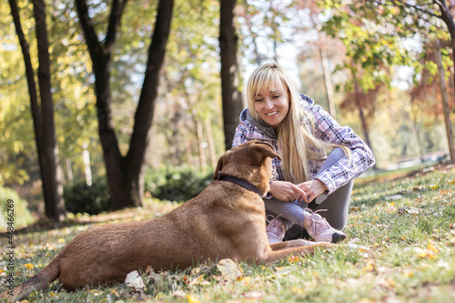 Positive young woman enjoying happy moments with her dog
