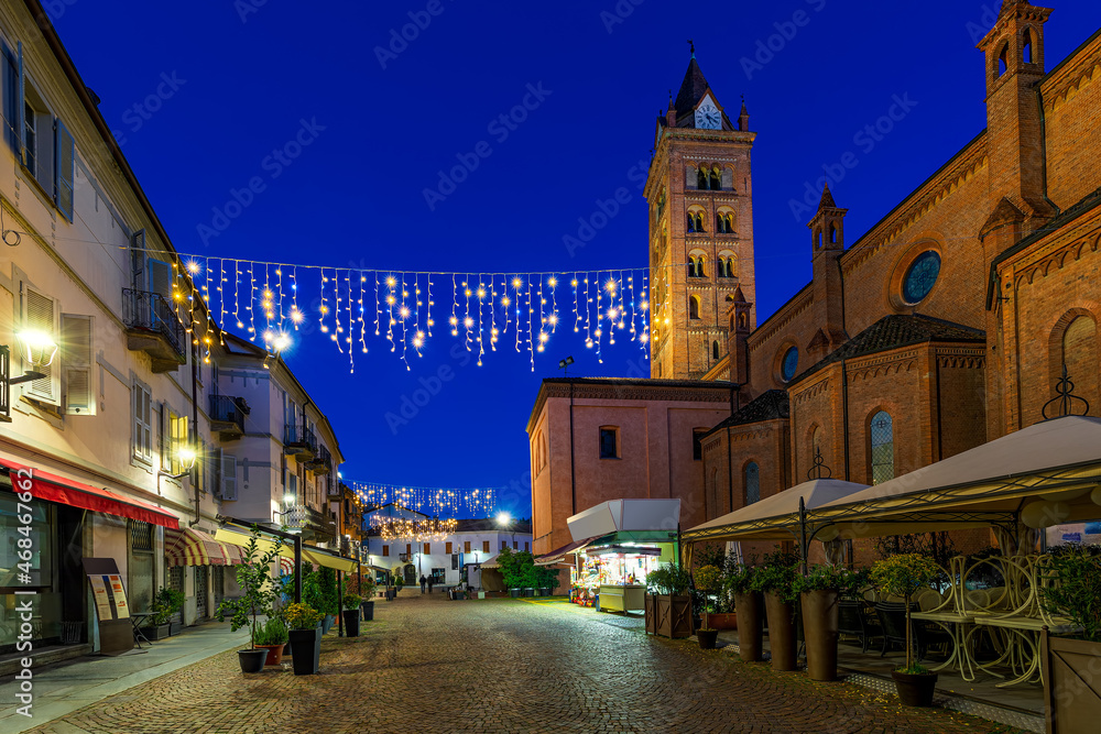 San Lorenzo cathedral and illuminated street in Alba, Italy San Lorenzo cathedral and illuminated street in Alba, Italy