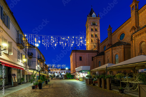 San Lorenzo cathedral and illuminated street in Alba, Italy