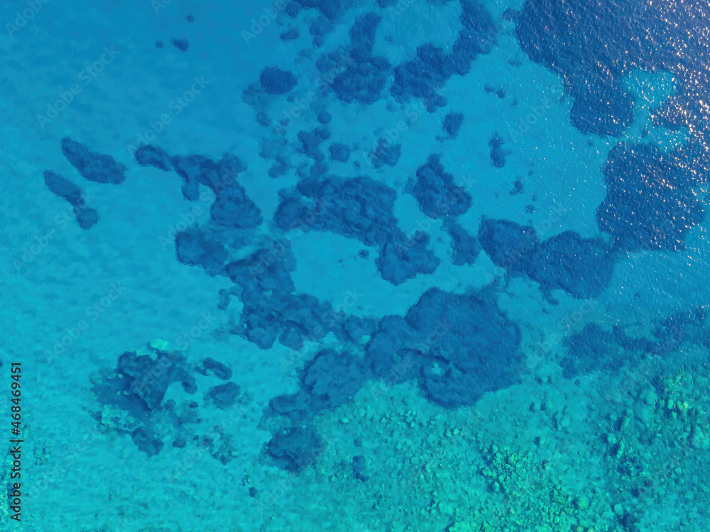 Background image of the turquoise sea. Deep sea and corals. Aerial drone shot of turquoise water - space for text. Aquamarine background