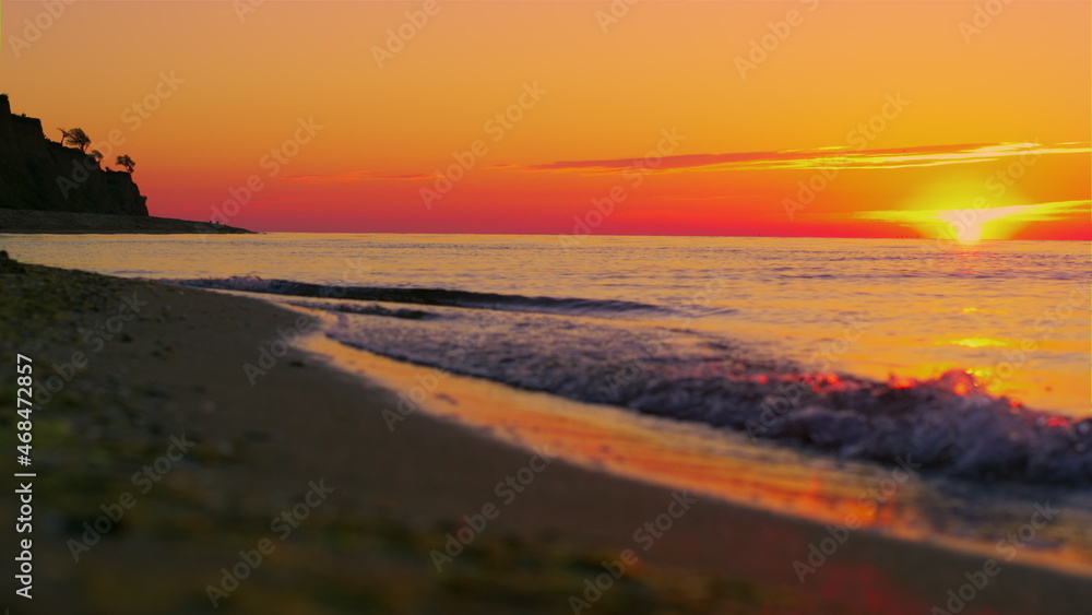 Panoramic landscape rock silhouette at orange sunrise morning. Ocean wave Panoramic landscape rock silhouette at orange sunrise morning. Ocean wave