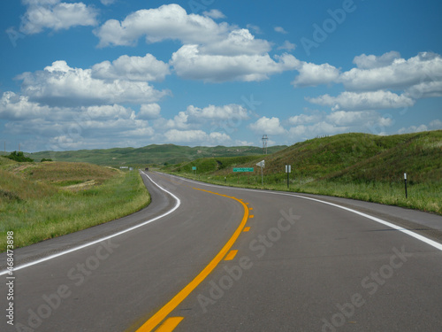 Winding road and beautiful clouds, Nebraska landscape, USA.