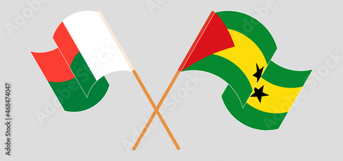 Crossed and waving flags of Madagascar and Sao Tome and Principe