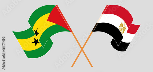 Crossed and waving flags of Sao Tome and Principe and Egypt
