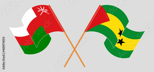 Crossed and waving flags of Oman and Sao Tome and Principe