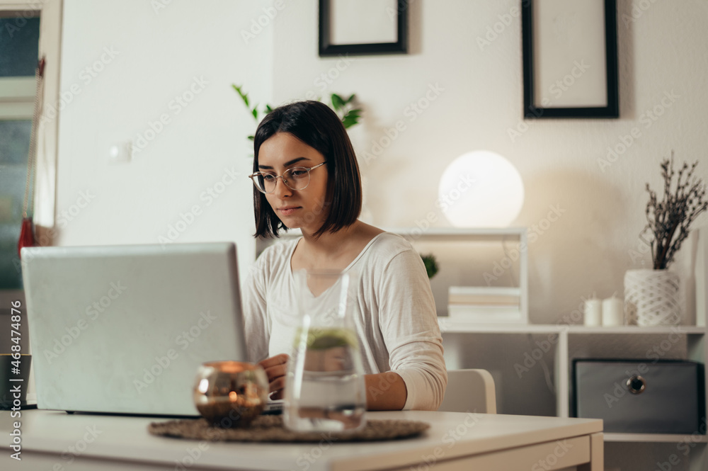 Beautiful woman using a laptop while working from home