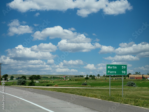 Roadside sign in Nebraska with directions to Martin and Pierre, South Dakota.