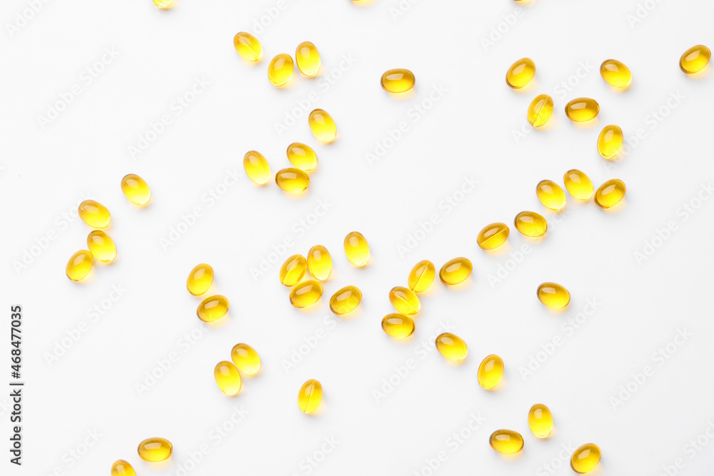 Many vitamin A capsules isolated on white background, closeup Many vitamin A capsules isolated on white background, closeup