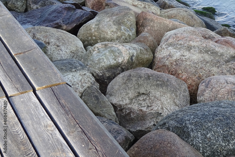 Closeup of a breakwater big grey and light brown stones by the seaside, full frame. Tallinn, Estonia, Europe