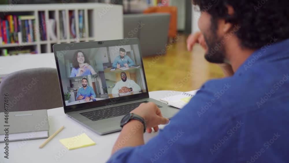 Indian man using app for distance video communication with coworkers by laptop Indian man using app for distance video communication with coworkers by laptop