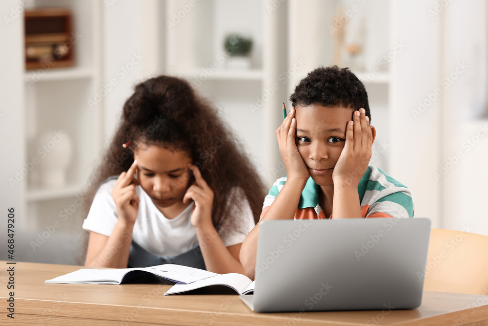 Little schoolchildren studying online at home Little schoolchildren studying online at home