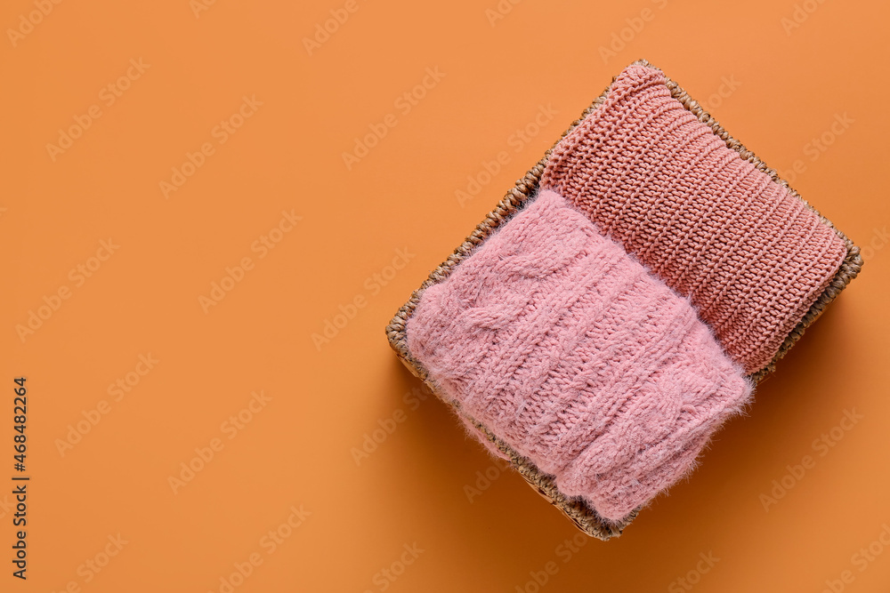 Basket with clean clothes on color background Basket with clean clothes on color background