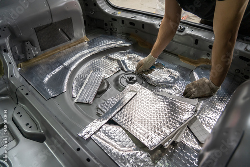Fotografie Process of installation of soundproofing material to inside of car