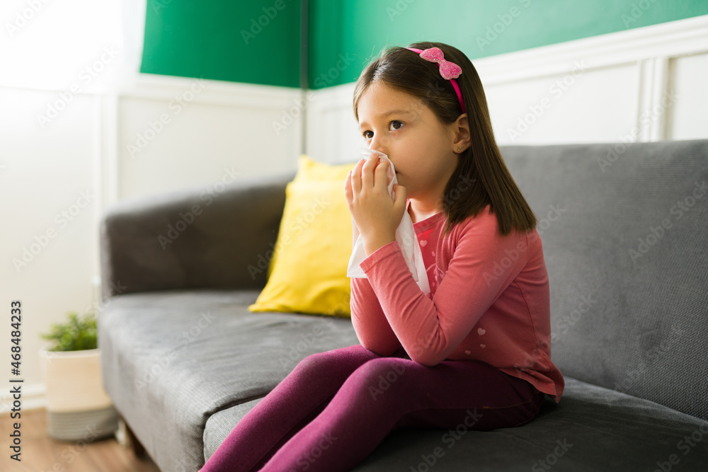 Sick young girl suffering from the flu Sick young girl suffering from the flu