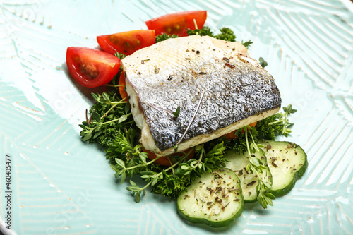 Delicious sea bass fish with vegetables on plate, closeup