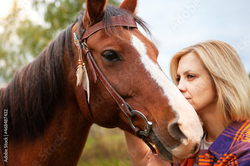Beautiful young blond woman with a horse, portrait. © наталья саксонова