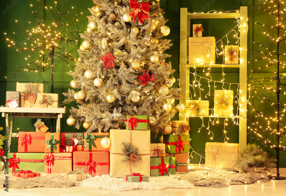 Many gifts under Christmas tree and glowing lights in room decorated for holiday