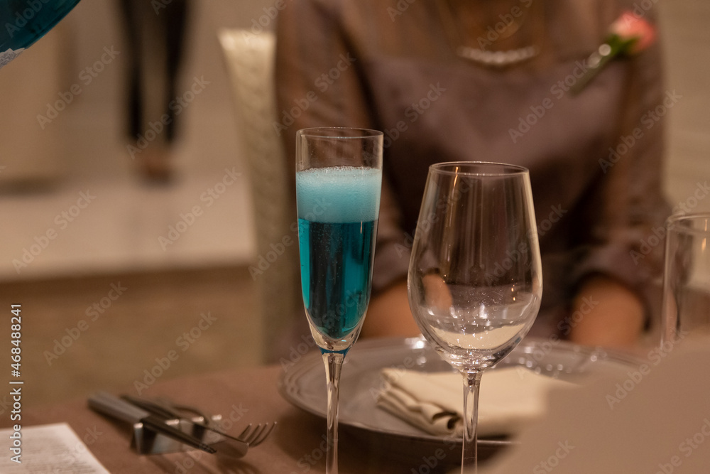 Non-alcohol blue champagne for wedding toast poured into glass in banquet hall in Japan Non-alcohol blue champagne for wedding toast poured into glass in banquet hall in Japan