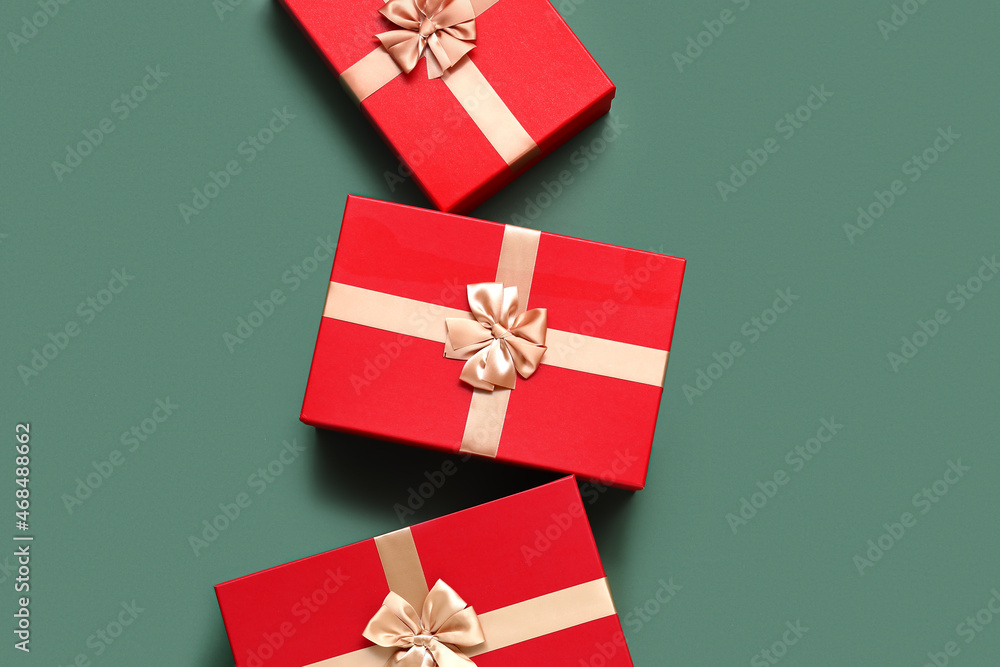 Red Christmas gift boxes on green background