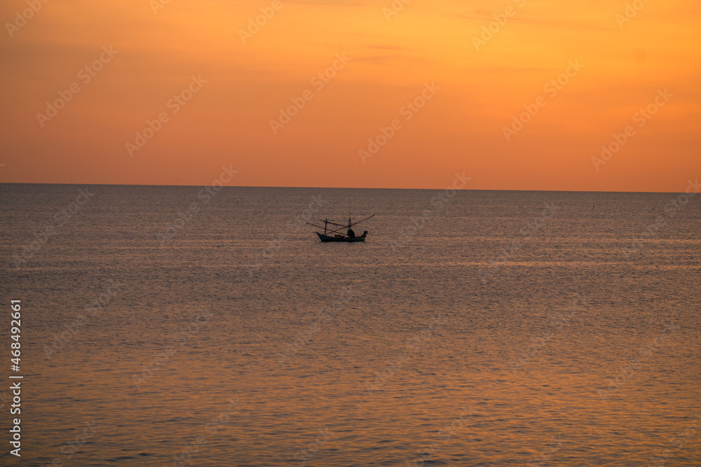 The background of the sea by the evening sea, with natural beauty (sea water, rocks, sky) and fishermen are fishing by the river bank, is a pleasure during travel.