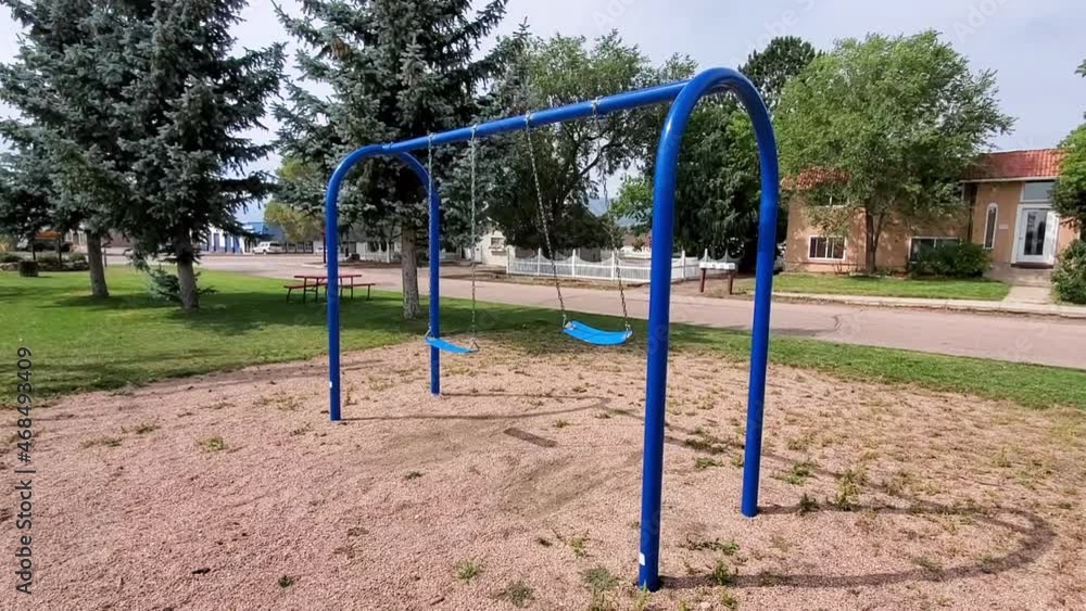 Empty Swing Waving at Public Playground During Covid-19 Virus Outbreak Lockdown and Quarantine, Colorado USA Empty Swing Waving at Public Playground During Covid-19 Virus Outbreak Lockdown and Quarantine, Colorado USA