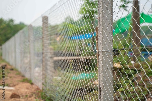 Chain link wire fences enclose border area,Wire fence. Metal net. Wire mesh. Metal grater grille background.