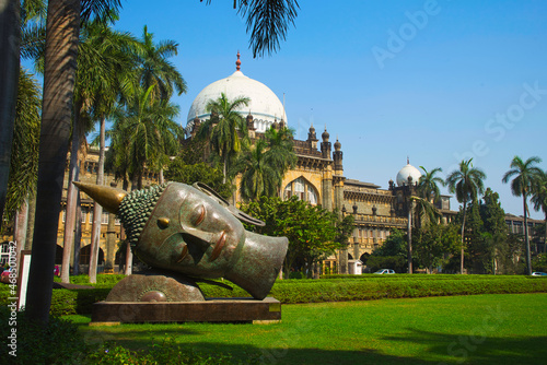 Buddha head carvings on the green grass of the museum. The Prince of Wales Museum (Chhatrapati Shivaji) is located in Mumbai, Maharashtra, India. photo