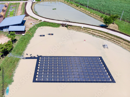 Solar panels farm between agriculture fields in aerial view. in Thailand
