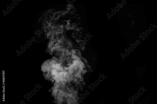 Fragment of white hot curly steam smoke isolated on a black background, close-up. Create mystical Halloween photos. Abstract background, design element © Alena