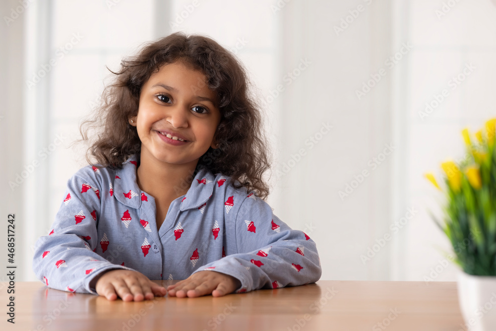 A beautiful girl looking at camera and smiling while posing A beautiful girl looking at camera and smiling while posing