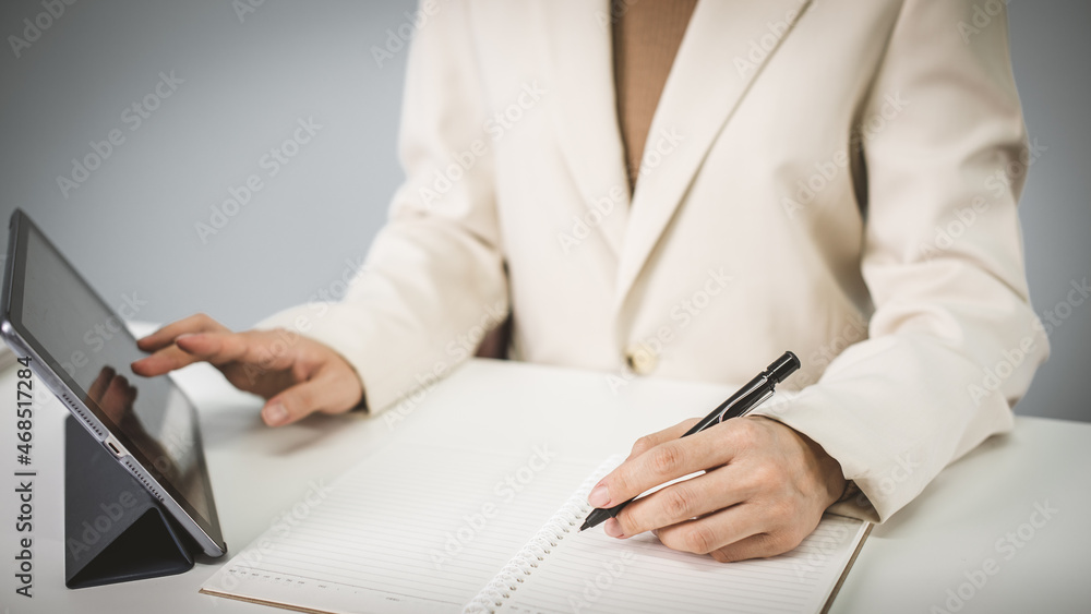 Business woman in suite working with documentary data on white desk at office, Business accounting and financial concept Business woman in suite working with documentary data on white desk at office, Business accounting and financial concept